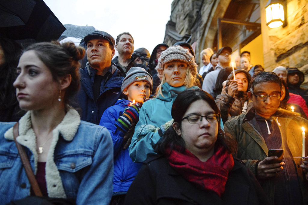 People stand on the stairs of the Sixth Presbyterian Church as the crowd spills up the hill and down the street for a vigil.