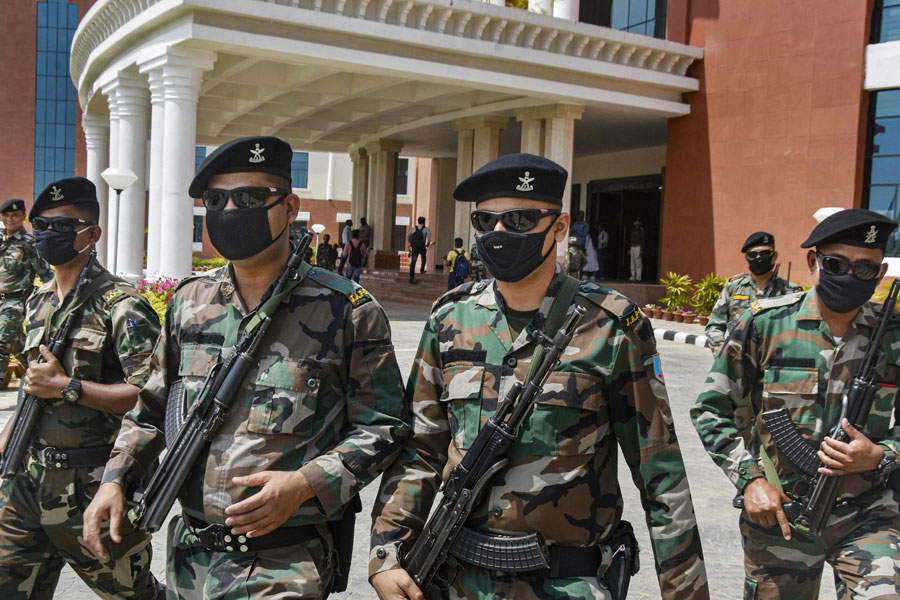 Jharkhand Armed Police (JAP) personnel wear masks as a precautionary measures against coronavirus at Jharkhand Assembly in Ranchi on Thursday