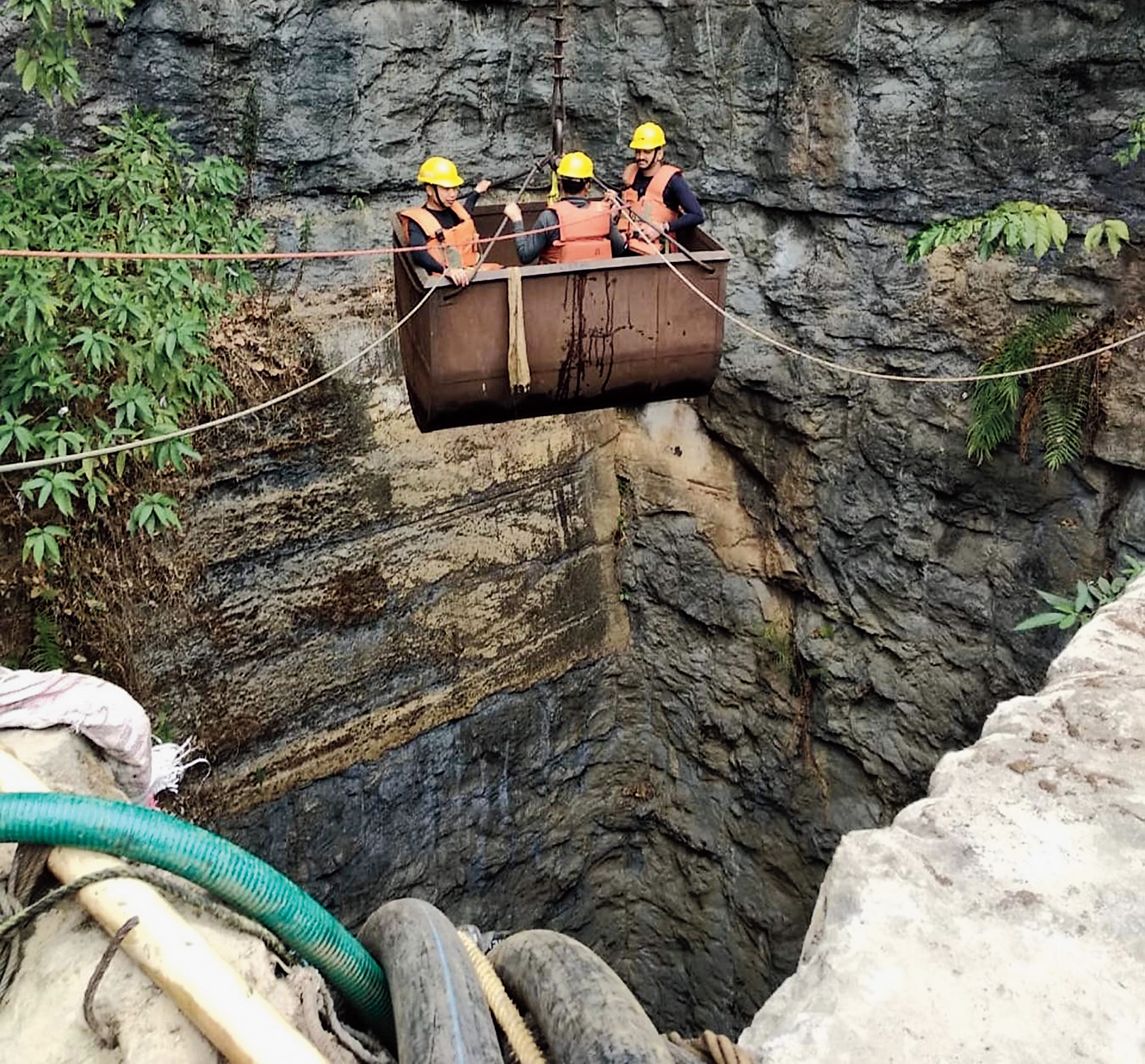 NDRF personnel enter the coal mine at Ksan in East Jaintia Hills for rescue operations. 