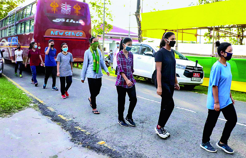 Keeping distance: Women walk towards a quarantine facility for screening at Tezpur in Sonitpur district on Monday. 