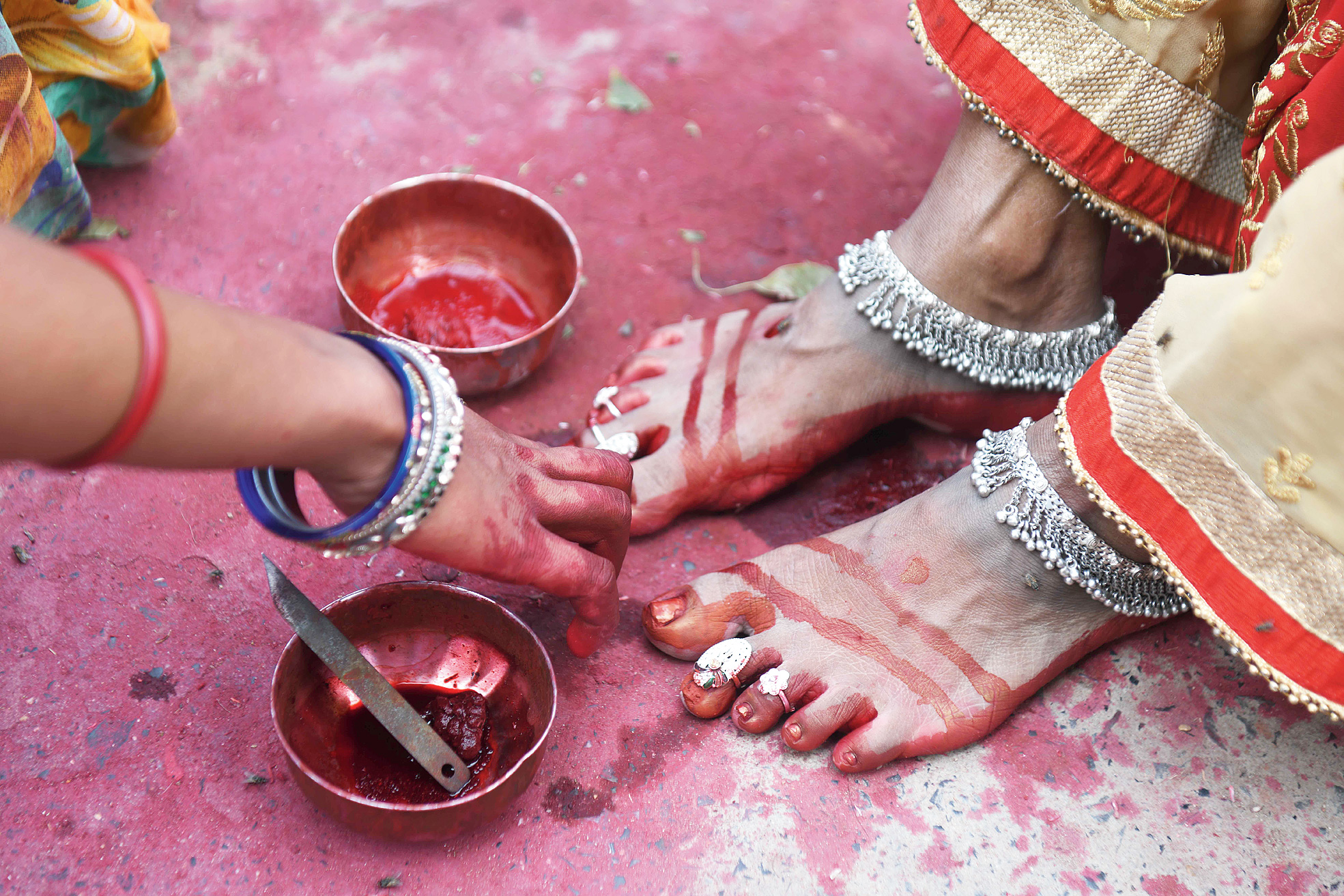 A woman gets her feet decorated at Khajekalan Ghat