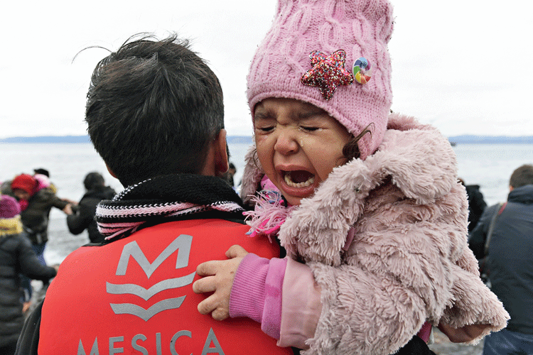 A girl cries after arriving in Skala Sikaminias, on the Greek island of Lesbos, after crossing the Aegean sea from Turkey  on Friday. 