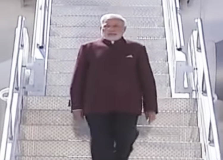 Modi, sporting a burgundy bandhgala suit, lands at the JFK airport in the US in 2014