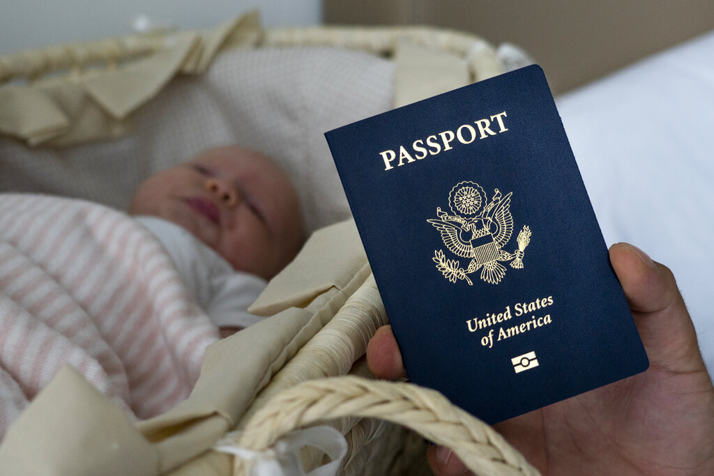 In this photo taken on January 24, 2019, Denis Wolok, the father of 1-month-old Eva, shows the child's US passport