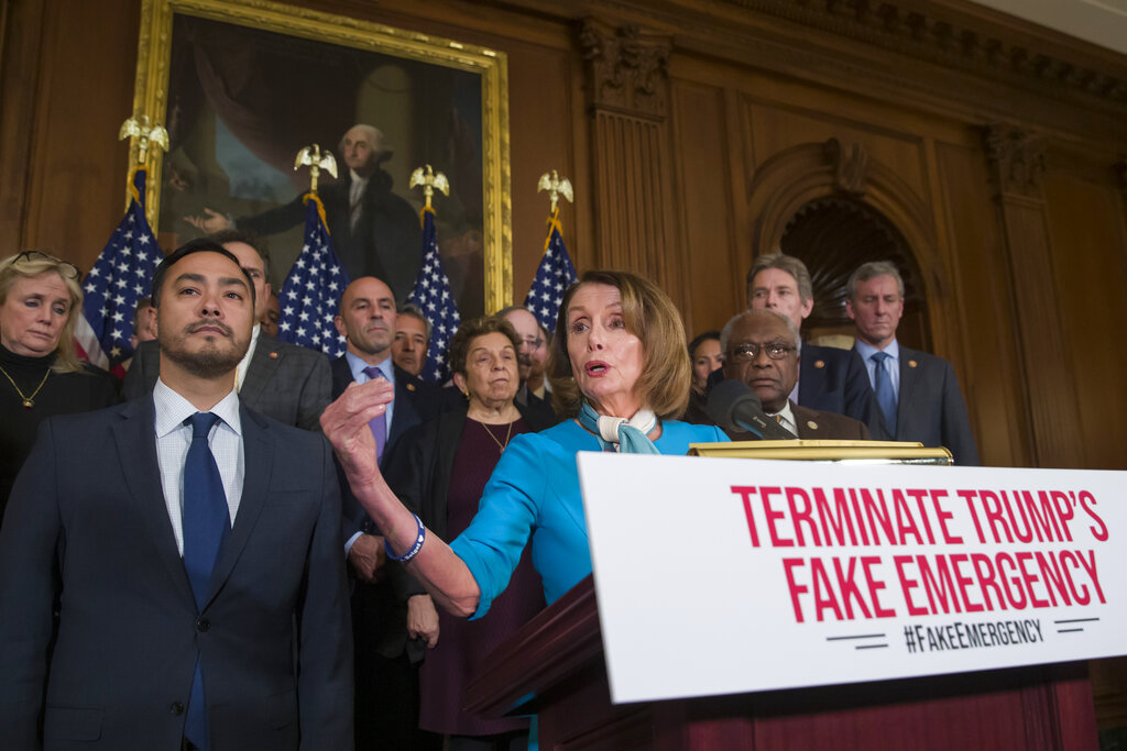 House Speaker Nancy Pelosi, accompanied by Representative Joaquin Castro (left) and others, speaks about a resolution to block Donald Trump's emergency border security declaration on Capitol Hill on Monday.