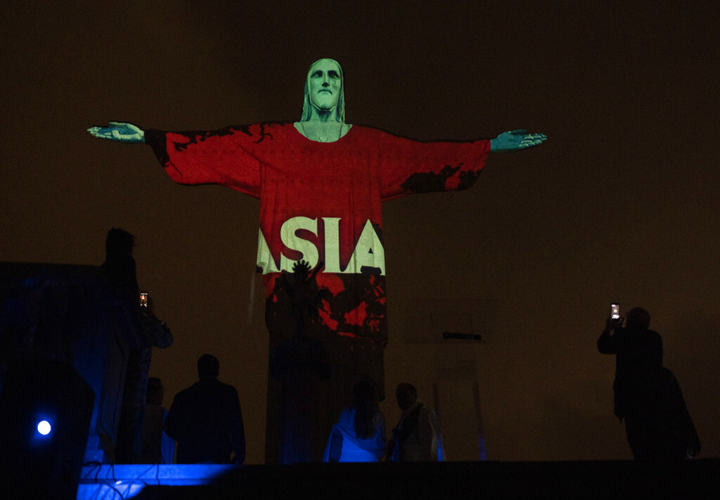 Rio's Christ the Redeemer statue is lit up with the word Asia in support of those afflicted by the new coronavirus, in Rio de Janeiro, Brazil, Wednesday, March 18, 2020.