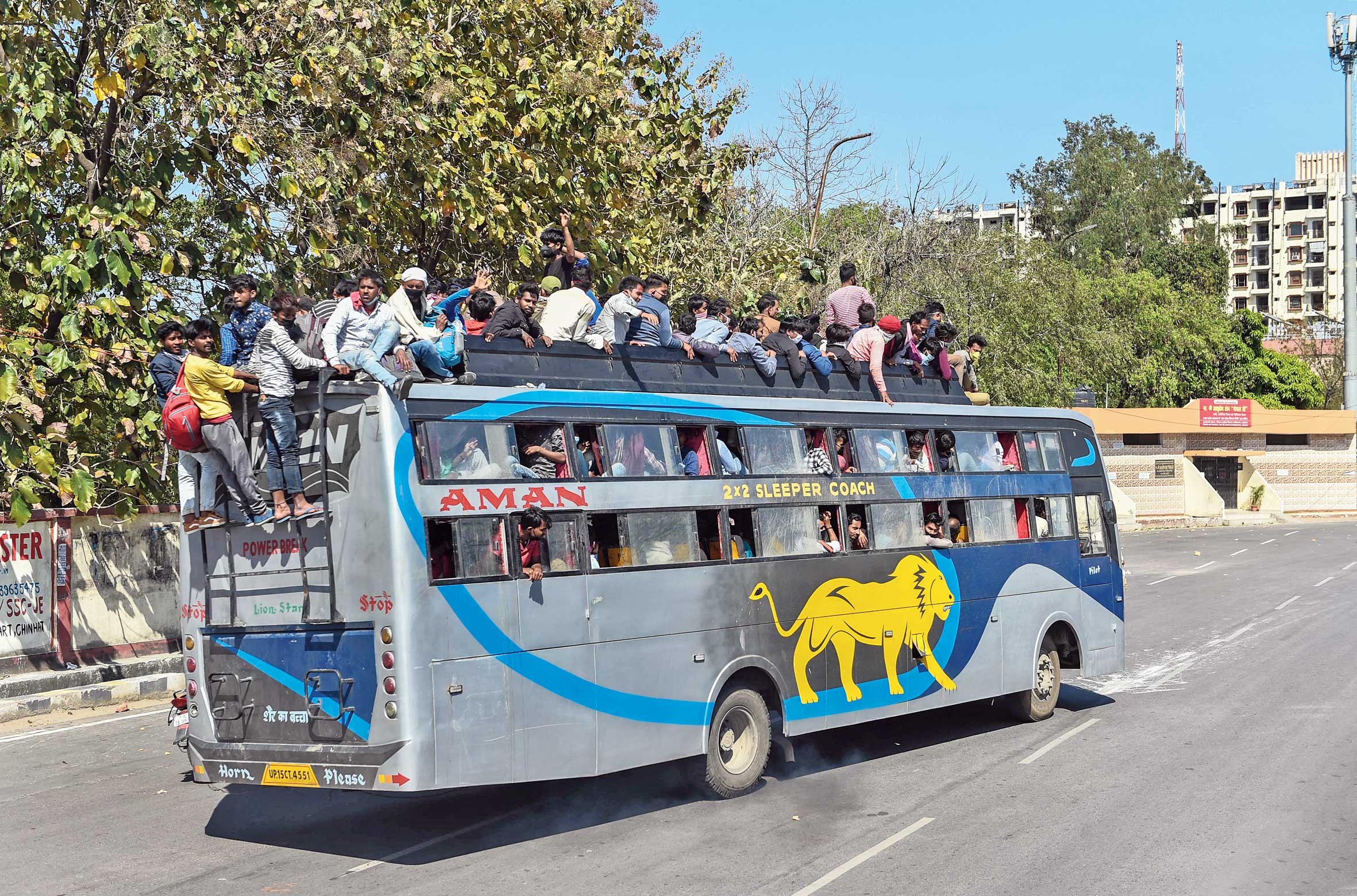 A bus overflowing with passengers leaves from Kamta bus stand in Lucknow on Sunday. 