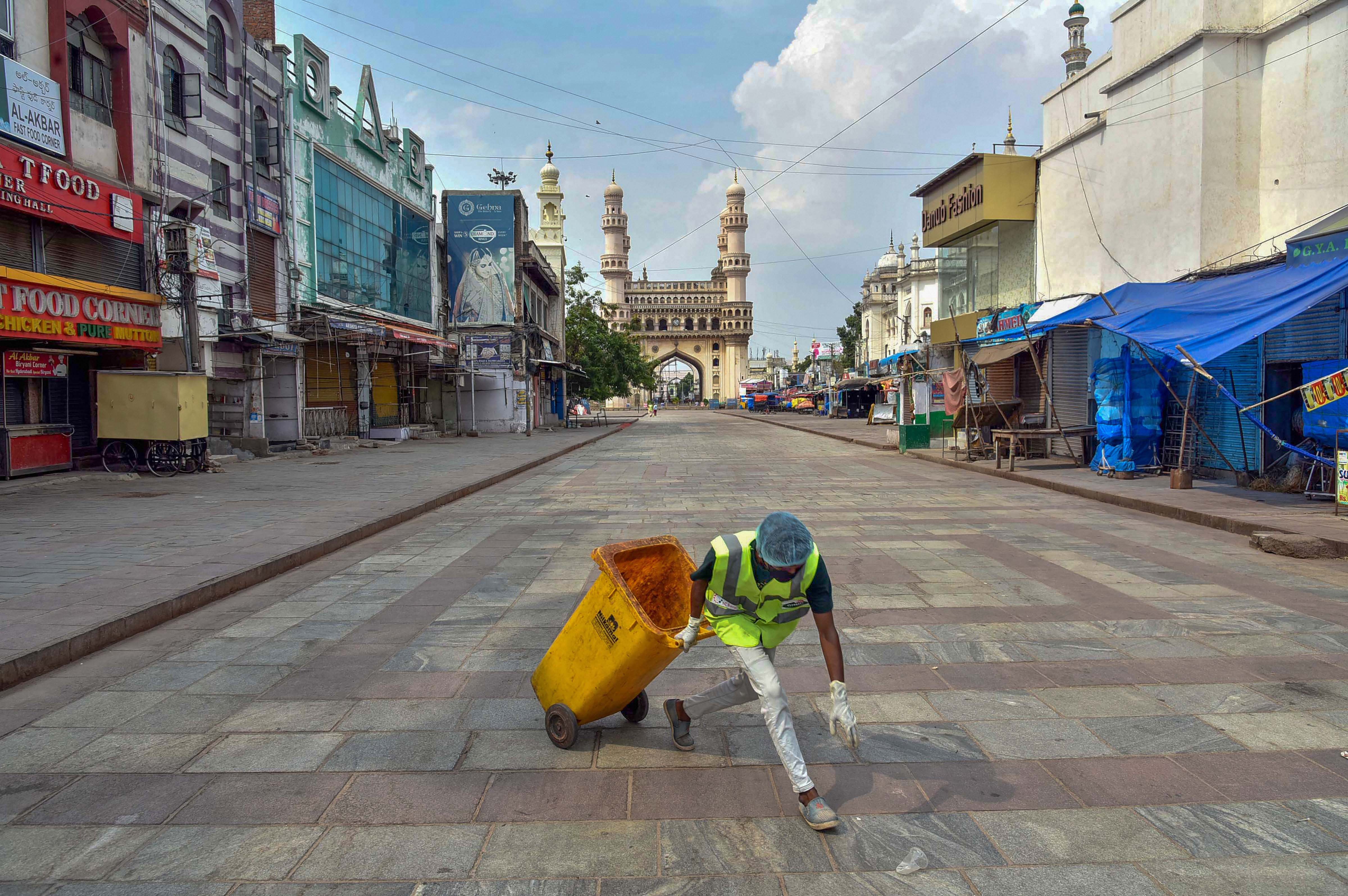 A GHMC worker cleans an area during the nationwide lockdown, imposed in wake of the coronavirus pandemic, in the old city of Hyderabad, Tuesday, April 7, 2020. 