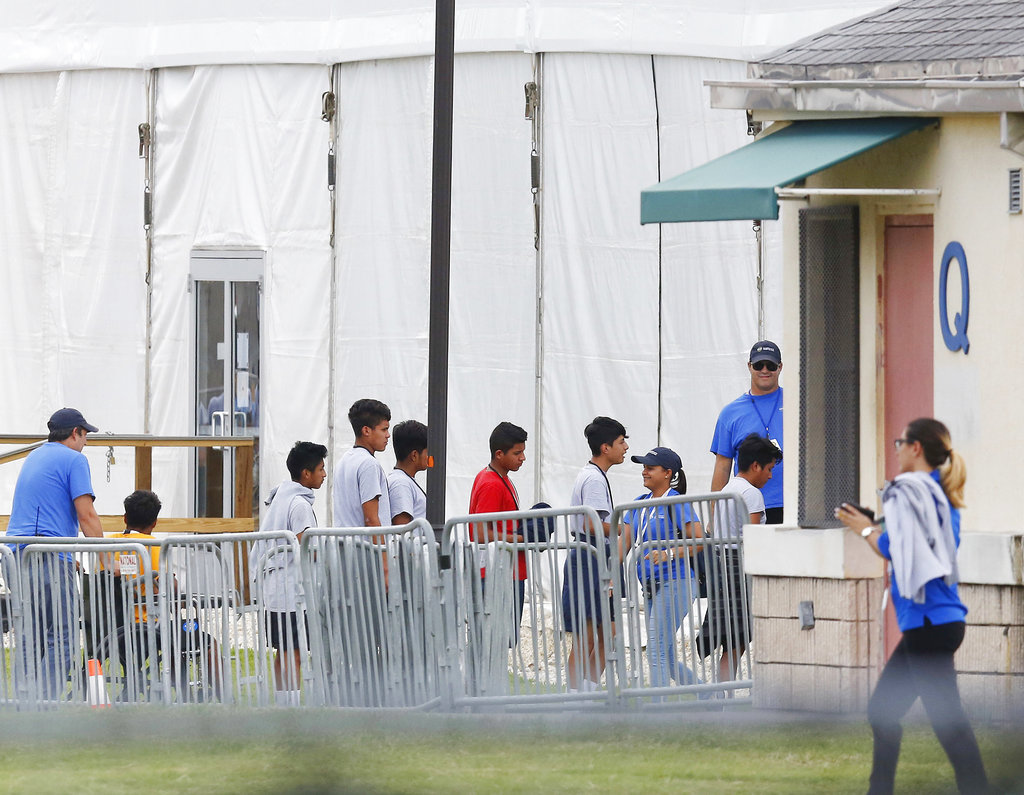 In this June 20, 2018, file photo, Immigrant children walk in a line outside a temporary shelter in Florida.