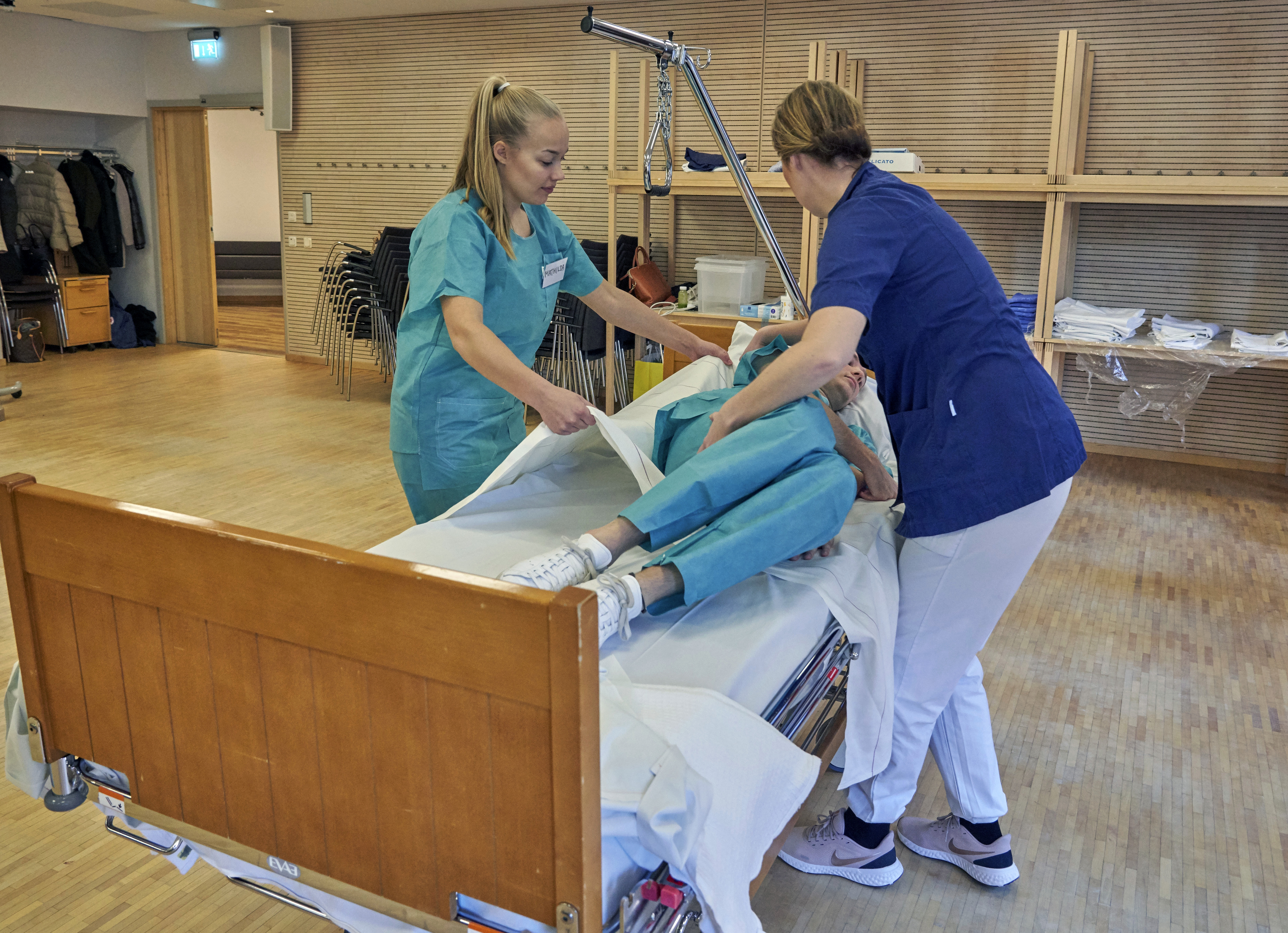 Former Scandinavian Airlines flight attendants learn basic skills on to assist in nursing homes and hospitals due to the coronavirus outbreak, in Stockholm