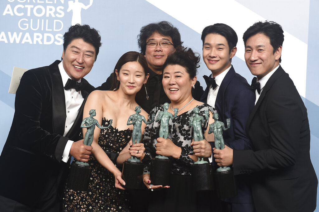 Kang-Ho Song, from left, Park So-dam, Bong Joon-ho, Jang Hye-jin, Choi Woo-shik, and Lee Sun Gyun pose in the press room with the award for outstanding performance by a cast in a motion picture for "Parasite" at the 26th annual Screen Actors Guild Awards at the Shrine Auditorium & Expo Hall on Sunday, January 19, 2020, in Los Angeles