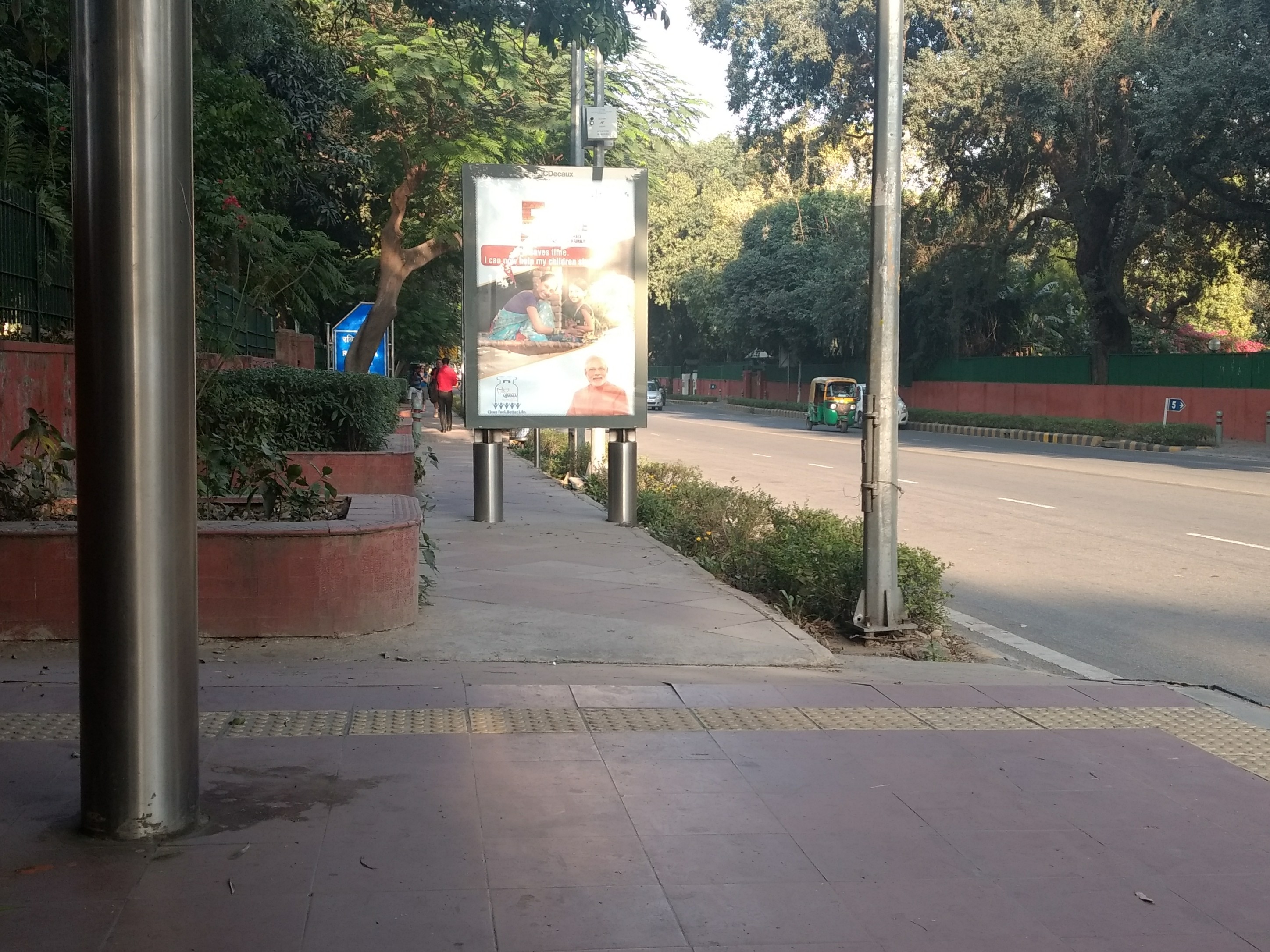 The national capital, Delhi, has buses and bus stops that are designed to be accessible to persons with disabilities. This bus shelter has ramps and tactile paving to help commuters who use wheelchairs or canes, but the kerb to reach it is permanently blocked by an advertisement. 