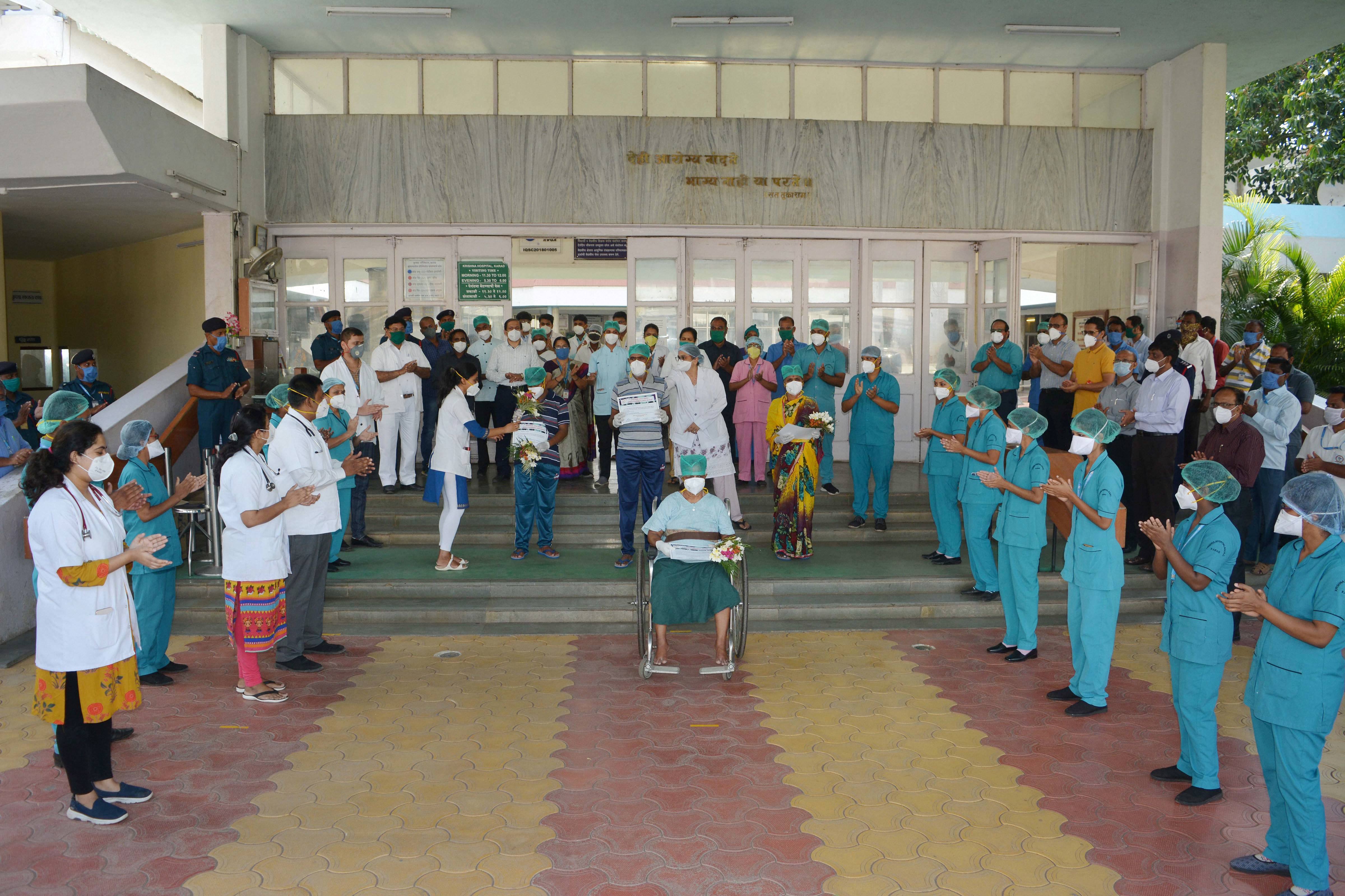 Medics and hospital staff applaud as patients who recovered from Covid-19 prepare to leave Krishna Hospital, during the ongoing Covid-19 nationwide lockdown, in Karad, Wednesday, May 13, 2020.