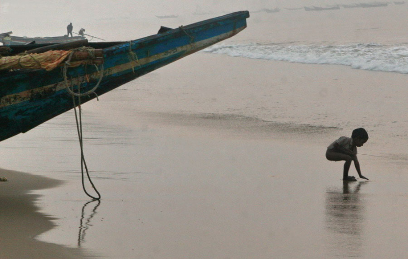 A homeless child on the beach in Puri