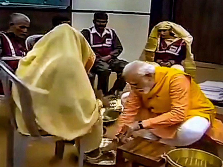 Prime Minister Narendra Modi washes the feet of sanitation workers during the 'Swachh Kumbh Swachh Aabhaar' event, in Prayagraj on Sunday, February 24. The manual scavengers have demanded proper daily wages and overtime, adequate equipment for health and safety, and insurance