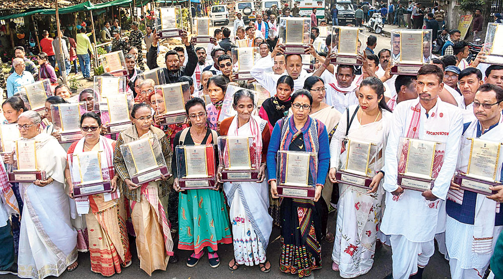 Family members of Assam Agitation martyrs in Guwahati on Wednesday with the mementos gifted to them by the state government. 
