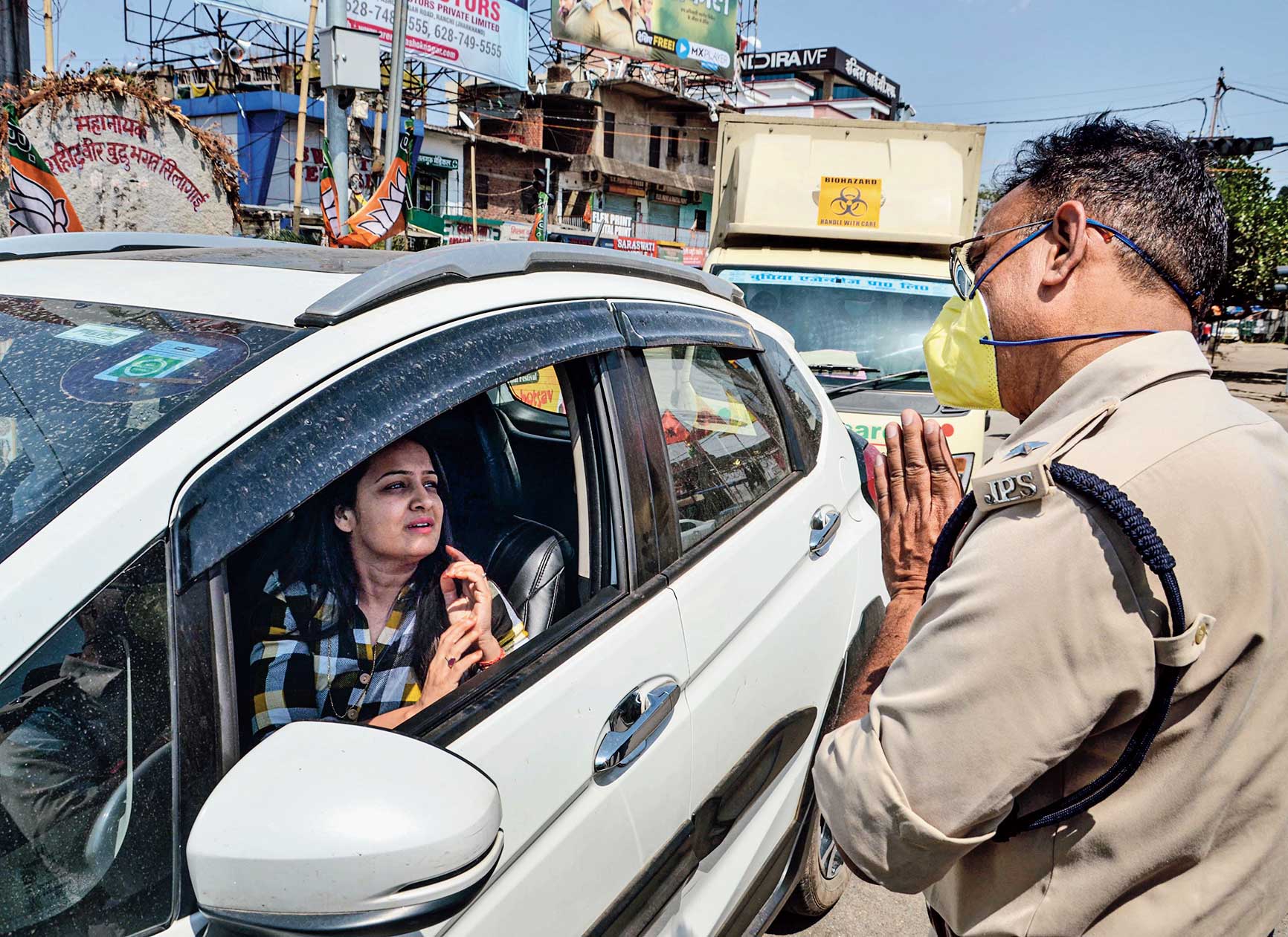 A police officer requests a commuter to stay home during the lockdown in Ranchi on Tuesday.