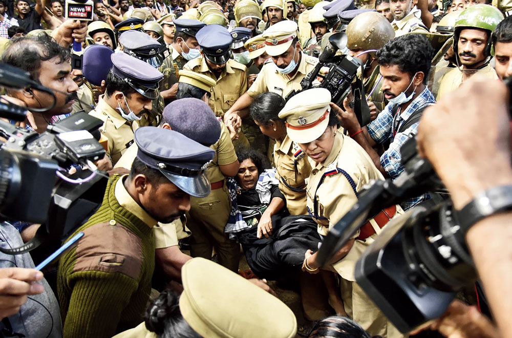 Police carry one of the women who fainted on her way to Sabarimala on Monday. 
