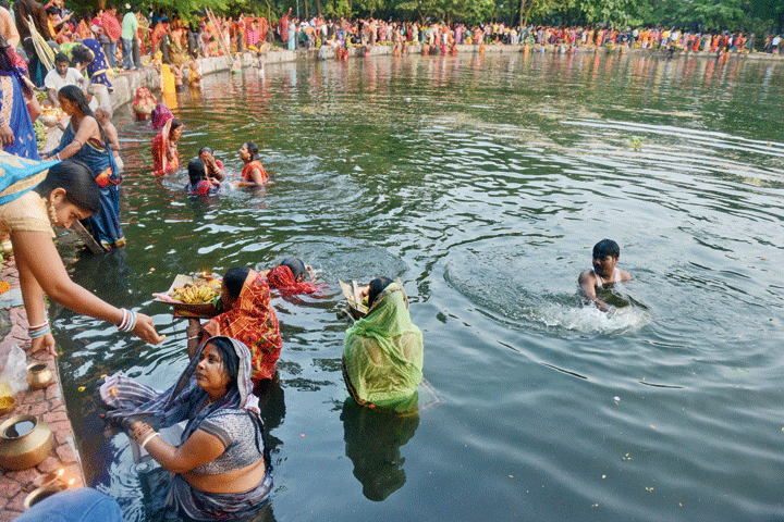 Chhath Puja devotees perform rituals at Rabindra Sarobar in Calcutta on Saturday