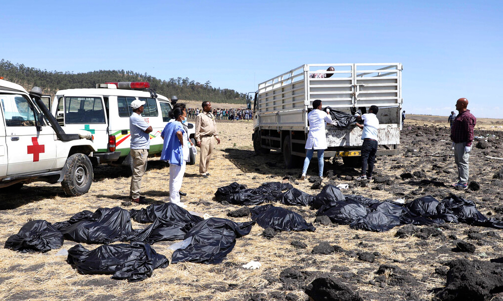 Rescuers remove body bags from the scene of an Ethiopian Airlines flight that crashed shortly after takeoff at Hejere near Bishoftu, or Debre Zeit, some 50 kms south of Addis Ababa in Ethiopia on Sunday, March 10, 2019.