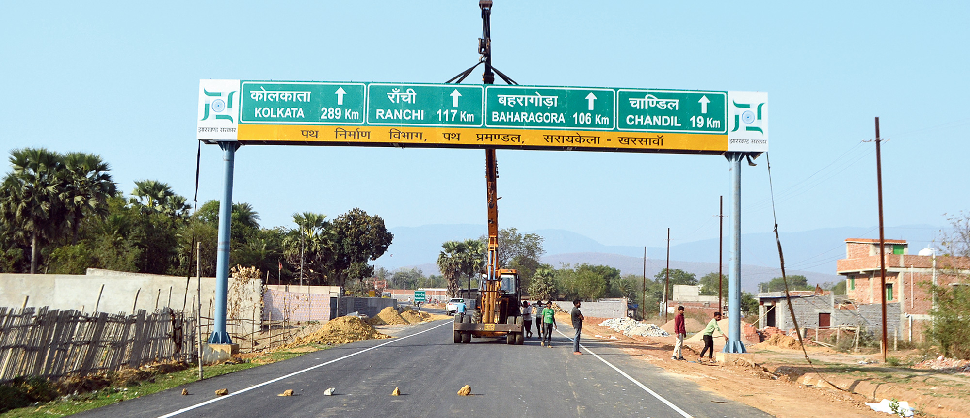 A signage being installed on the Dobo-Kanderbera road in Seraikela-Kharsawan on Sunday. 