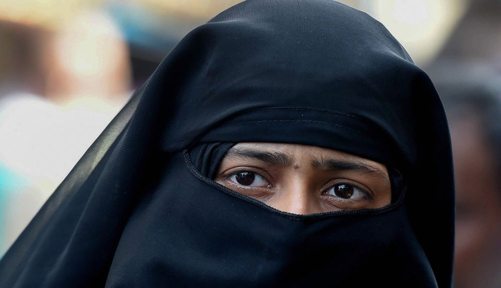 A Muslim woman looks on near Jama Masjid in New Delhi on Wednesday.