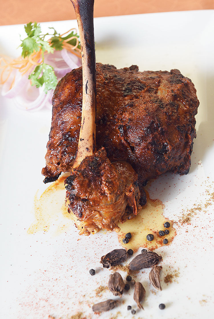 Shaan-E-Raan Musallam: Baby lamb legs are stuffed with cheese, dry anardana (pomegranate seeds) powder, coriander, crushed pepper and then sewn in order to keep the stuffing from spilling out. The meat is then marinated and boiled for three to four hours and the jus is reduced and served, while the raan is further marinated and cooked in the tandoor. This long process and use of a variety of ingredients make the meat succulent with a burst of flavours. Rs 850