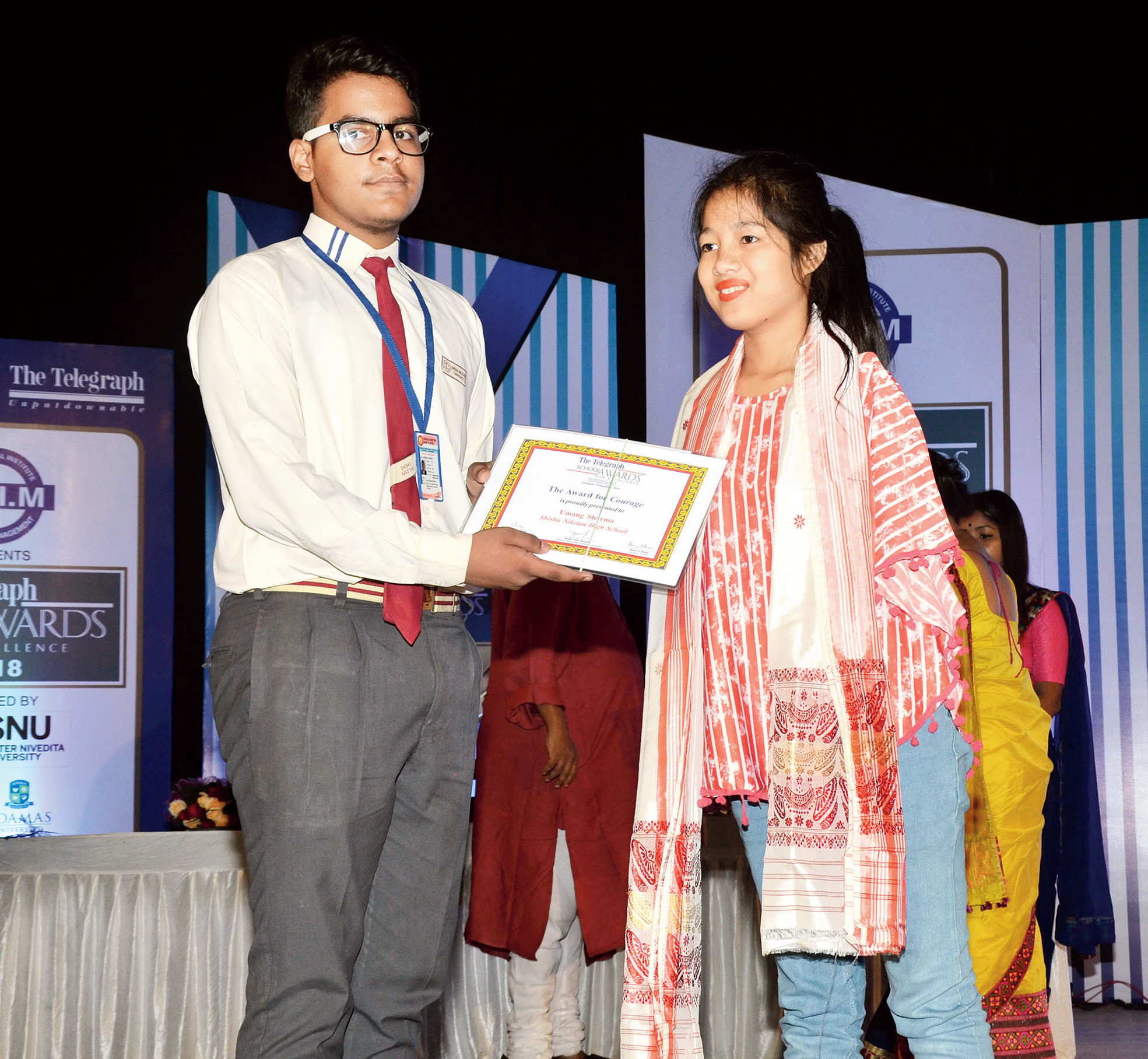 Umang Sharma receives The Telegraph Education Foundation Award for Courage from Princy Gogoi in Guwahati on Saturday. 