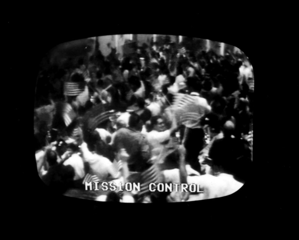 Mission Control in Houston erupts in flag-waving celebration after the safe return to the Earth of the Apollo 11 astronauts
