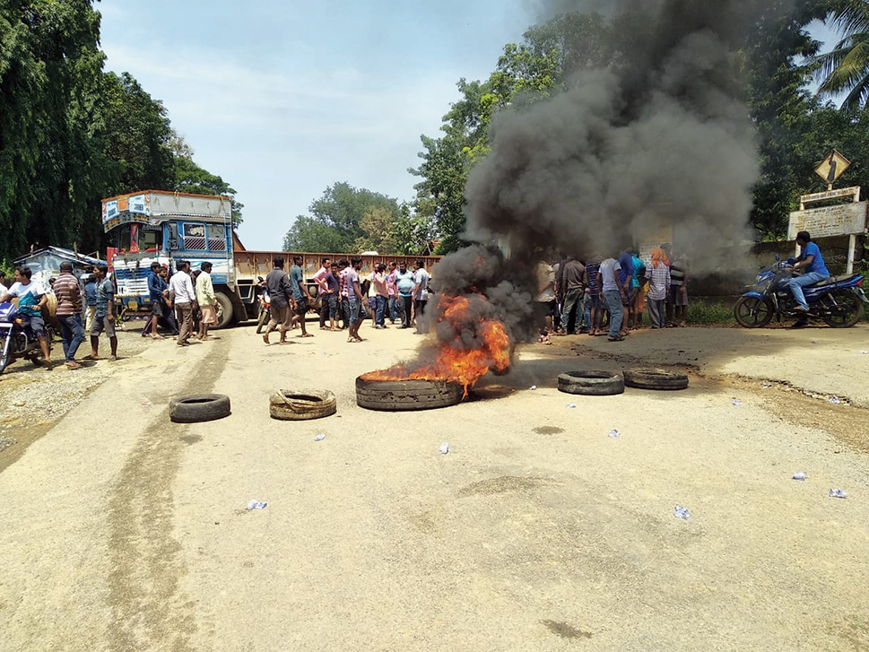 Villagers burn tyres to protest against alleged delay in supply of relief materials in Malkangiri.