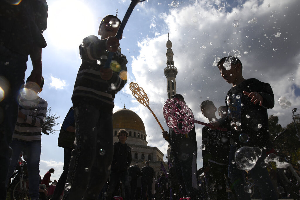 Israeli Arab kids play with soap bubbles during a protest against U.S. President Donald Trump's Mideast initiative, in the Israeli Arab town of Jaljulia, Israel