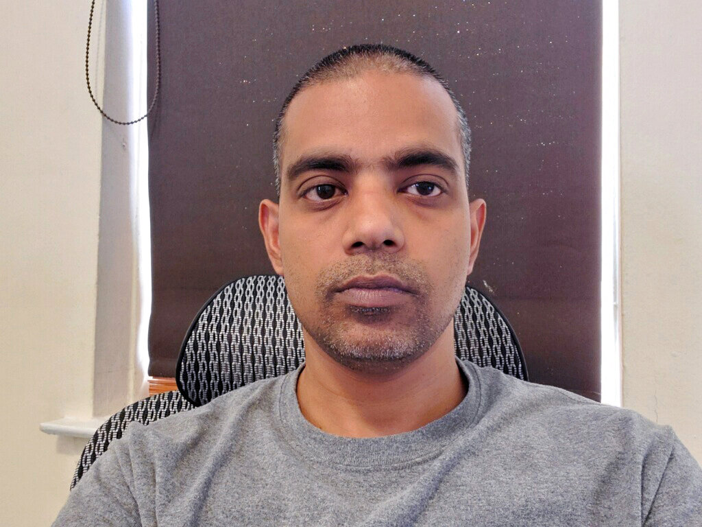 In this Thursday, March 26, 2020 photo provided by Benny Mathew, Benny Mathew is shown at his home in the Bronx borough of New York. Matthew, a nurse at Montefiore Medical Center, was diagnosed earlier in the day with COVID-19 and is now worried he may infect his wife and two daughters.