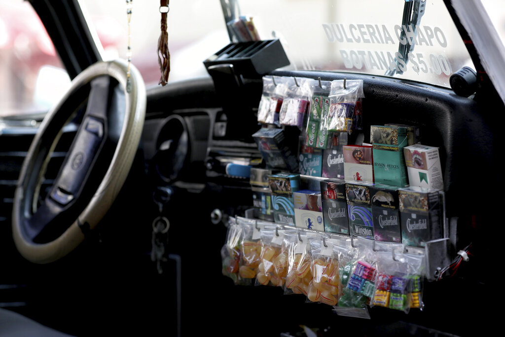 Candy and cigarettes for sale inside a Volkswagen Beetle in Mexico City. Among aficionados in Cuautepec, there's some concern that Beetle-mania may come to an end as parts become increasingly hard to come by.