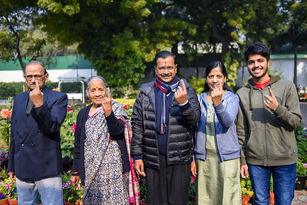 Delhi Chief Minister and AAP convenor Arvind Kejriwal and his family members show their finger marked with indelible ink after casting vote during the Delhi Assembly elections at a polling station, in Civil Line area of New Delhi