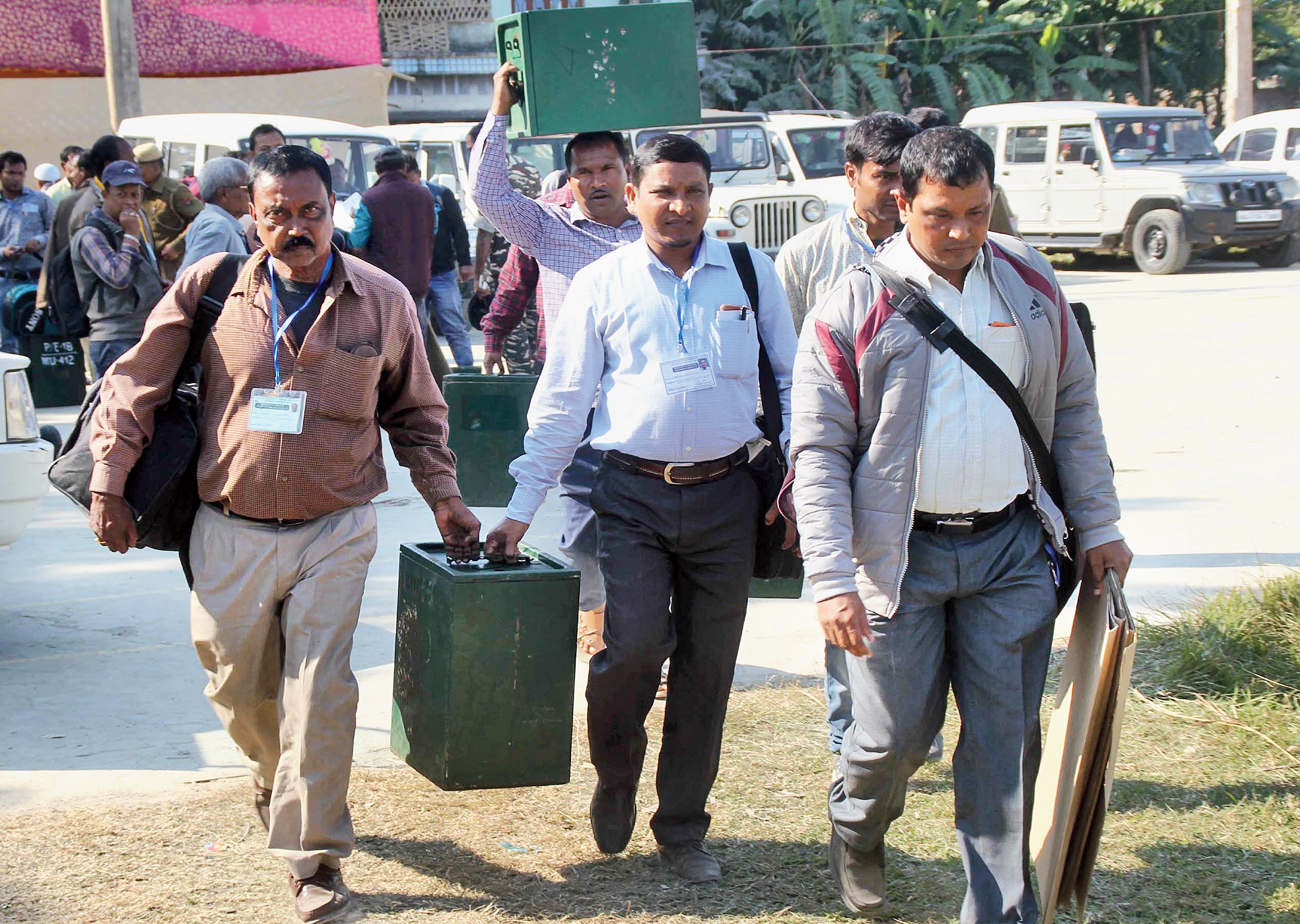 Polling officials carry election materials as they leave for booths in Dhubri on Saturday, the eve of the second phase of panchayat polls.