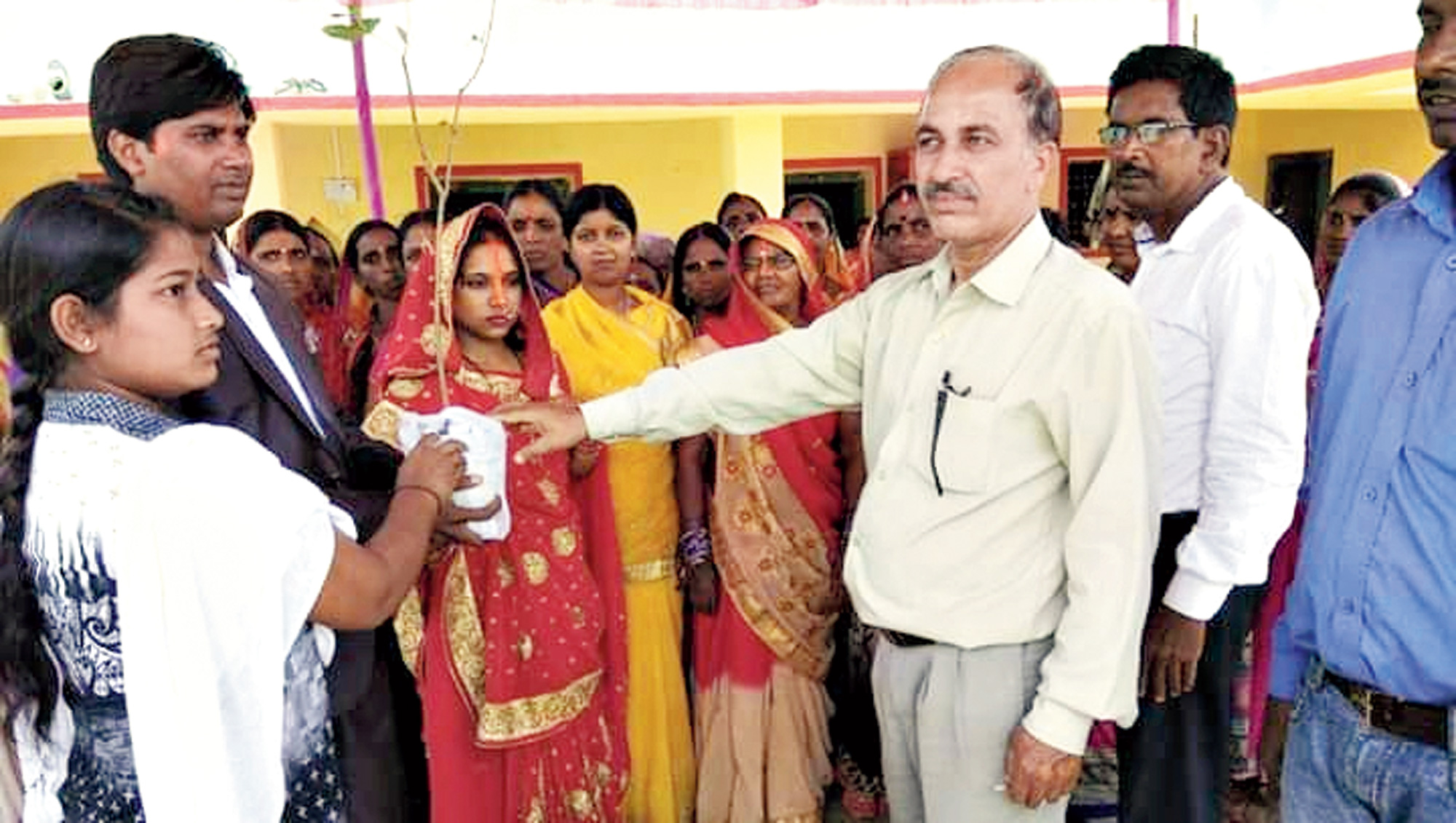 Best wishes: Shivshankar Gope presents saplings to a newly wed couple in Giridih last month.
