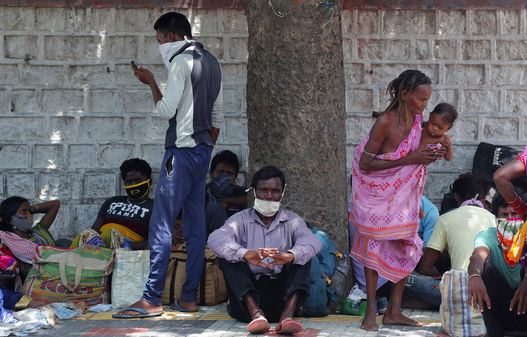 Migrant workers from Odisha state rest on a pavement as they wait for trains to their home states in Hyderabad, Tuesday, June 9, 2020.
