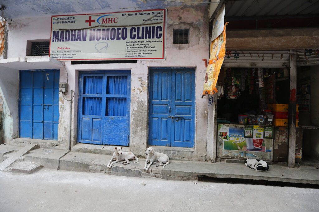 Street dogs rest in an alley during lockdown to prevent the spread of new coronavirus in Prayagraj, on Saturday, April 25, 2020.