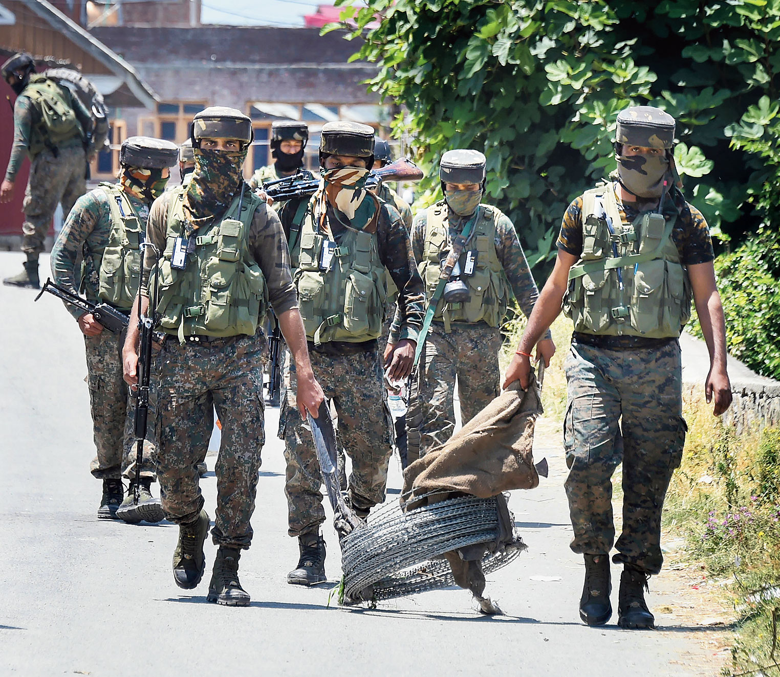 Security personnel leave after an encounter with militants at Zoonimar in Srinagar on Sunday. Three militants were killed in the encounter.