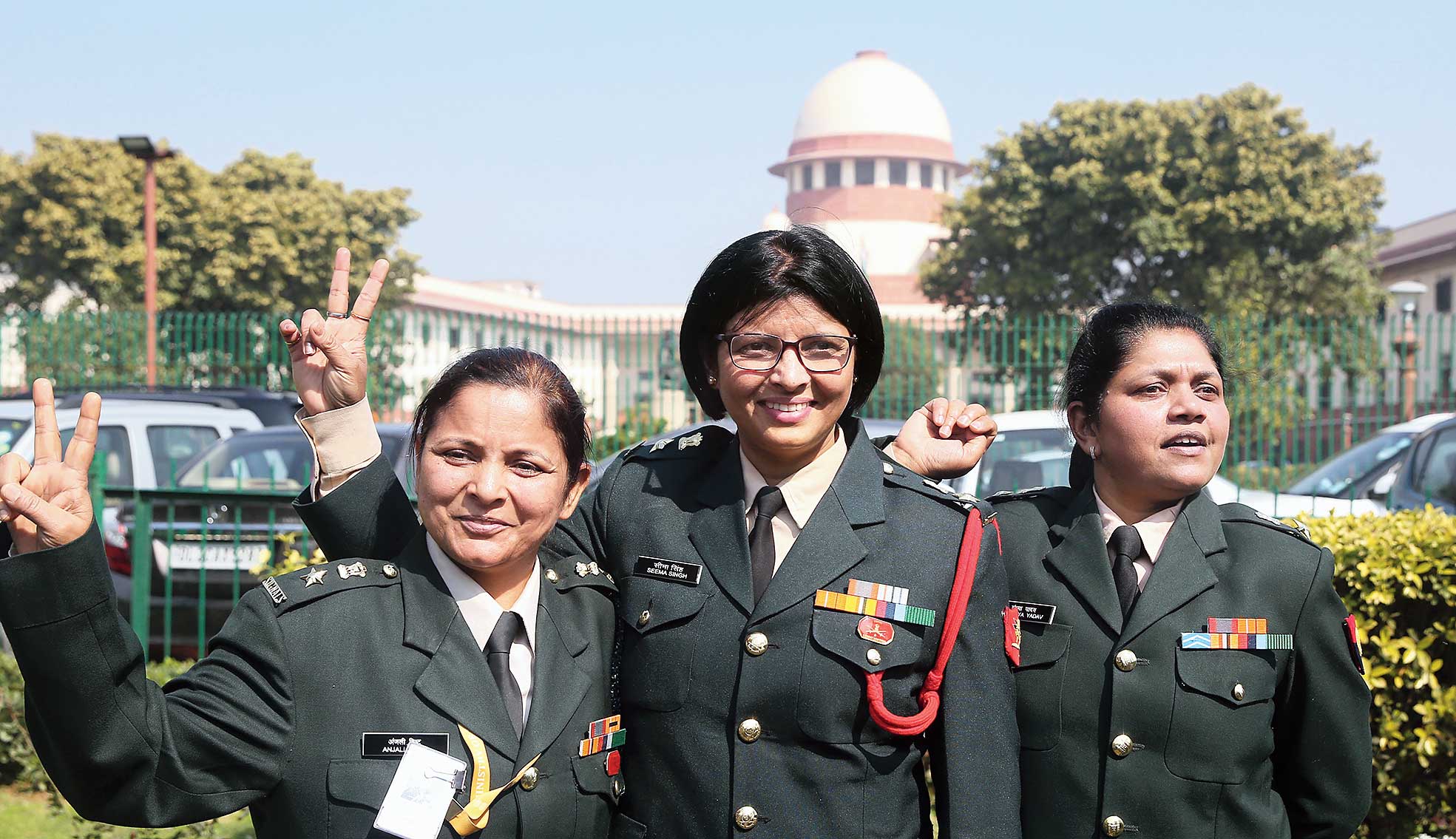 (From left) Short Service Commission officers Anjali Bisht, Seema Singh and Sandhya Yadav flash victory sign outside the Supreme Court. 