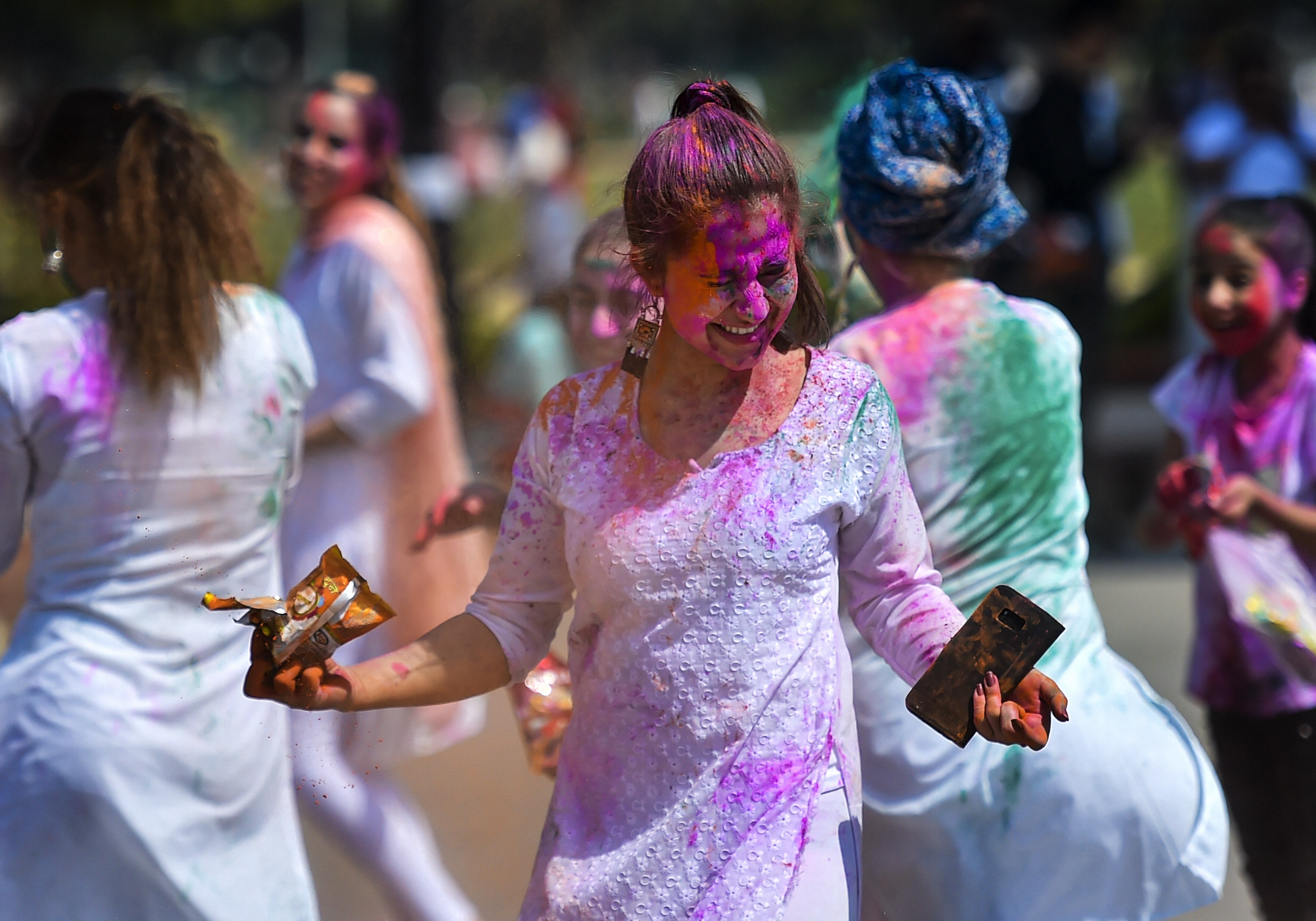 Afghan nationals play with dry colours during Holi celebrations in New Delhi, Tuesday, March 10, 2020