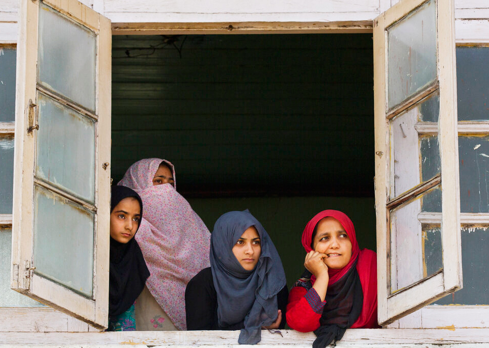 Kashmiri women watch from the window of a mosque at a protest rally in Srinagar on Friday, September 27, 2019.