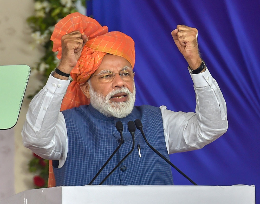 Narendra Modi at the launch of a pension scheme for unorganised workers in Ahmedabad on Tuesday. The Prime Minister said during the day that Opposition “persons have become poster boys of Pakistan by terming it an ambassador of peace”. 
