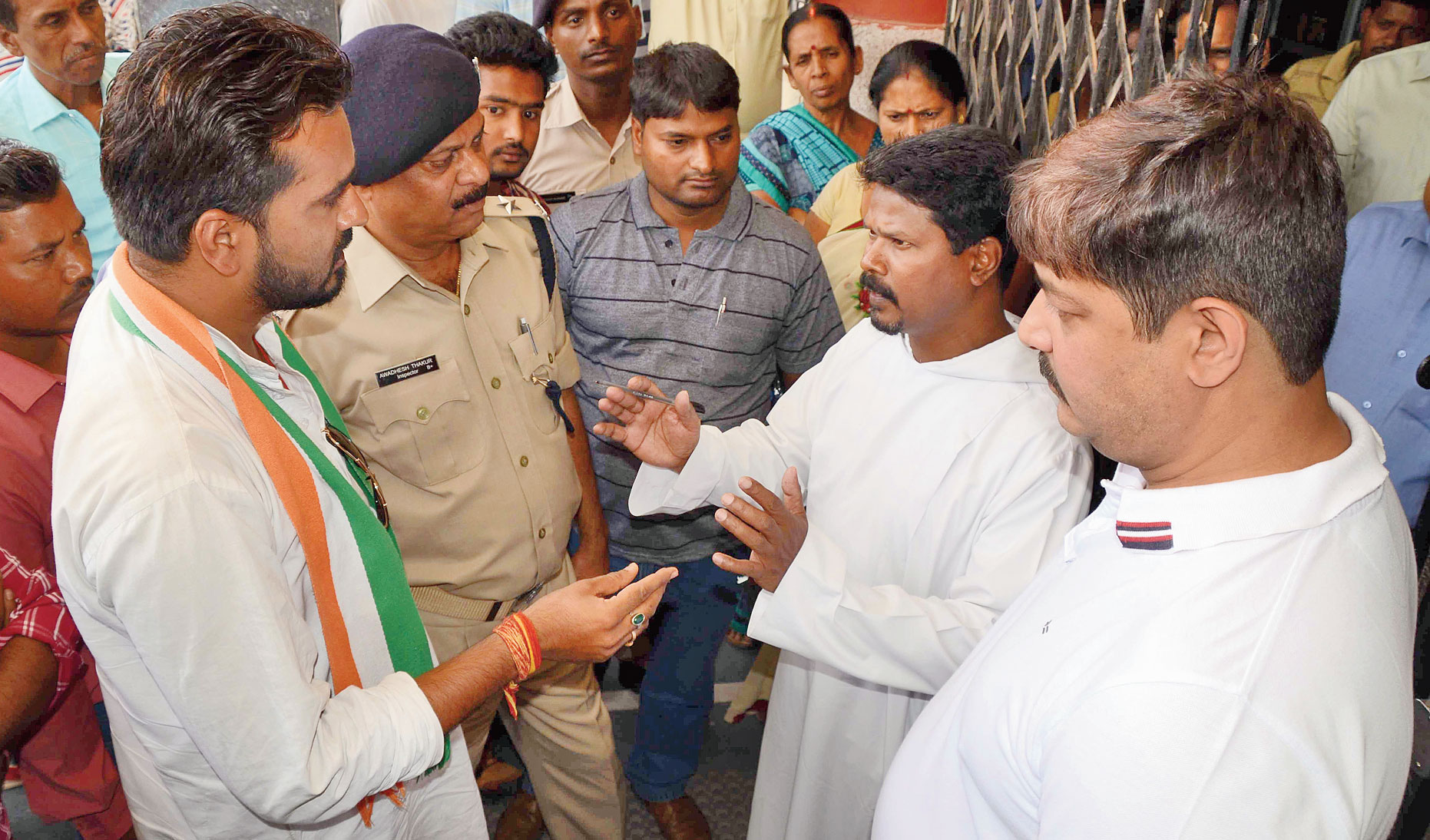Principal of Bishop Hartmann Academy T Kindo (right) interacts with police and NSUI student leader Indrajeet Singh in Ranchi on Thursday. 