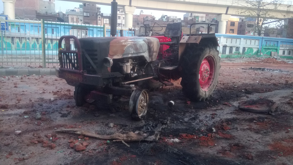 A tractor that was set on fire by protesters