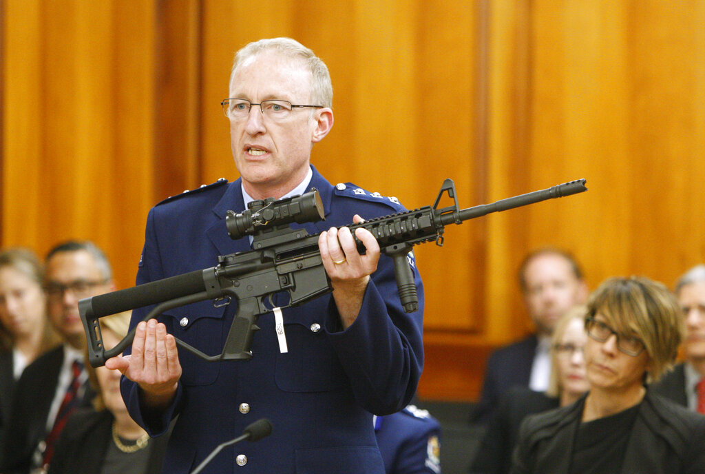 In this April 2, 2019, file photo, Police acting superintendent Mike McIlraith shows New Zealand lawmakers in Wellington, New Zealand, an AR-15 style rifle similar to one of the weapons a gunman used to slaughter 50 people at two mosques.