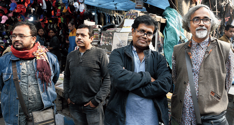 Art college teachers (from left) Partha Gayen, Pradip Mondal, Arup Das and Tanmoy Banerjee stood at the gate of the institute. As the rally approached, they clicked pictures and eventually joined in