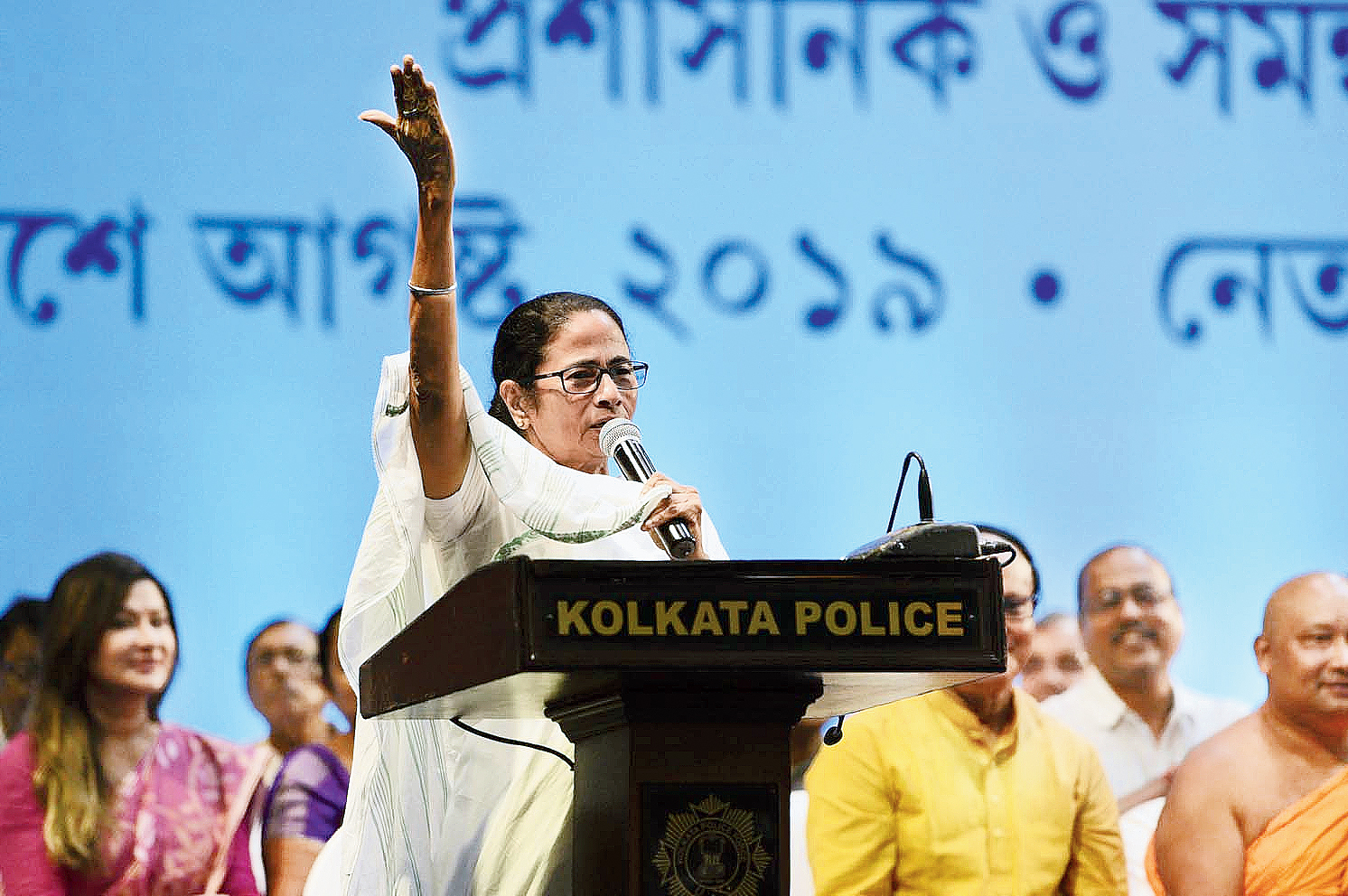 Chief minister Mamata Banerjee raises her hand to seek mandate from the audience on whether VIP passes and gates would be done away with during this year’s Durga Puja.