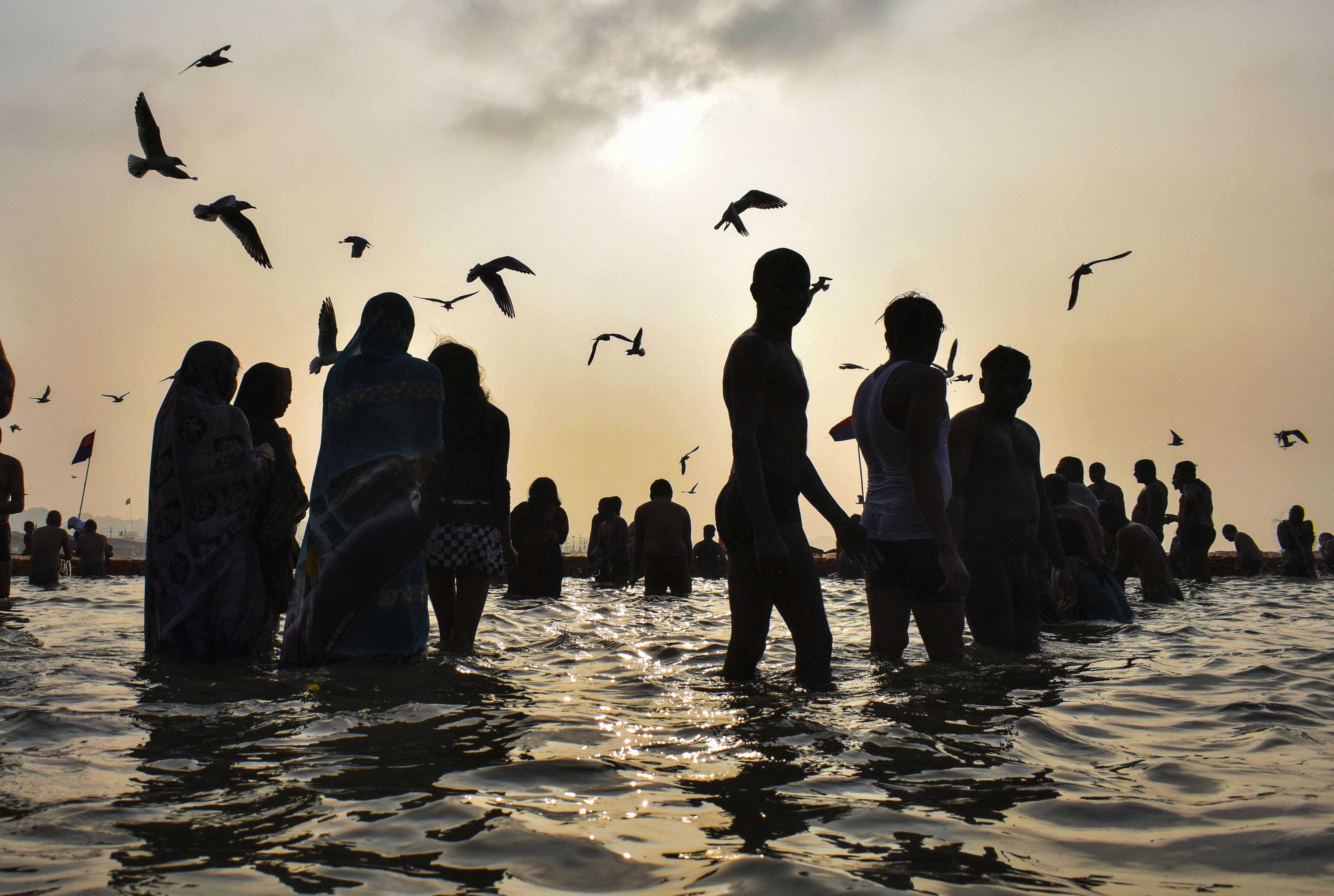 Devotees gather at Sangam to take a holy dip on the occasion of Basant Panchami during the ongoing Magh Mela in Prayagraj, Thursday
