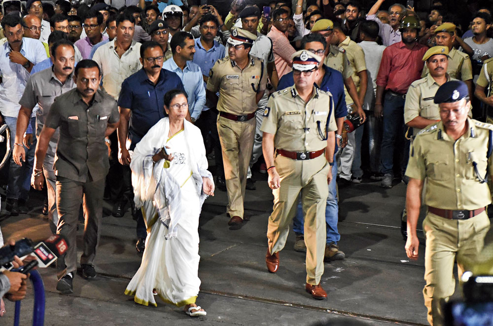 Mamata leaves Vidyasagar College for Calcutta University, accompanied by city police commissioner Rajesh Kumar (to her left), on Tuesday